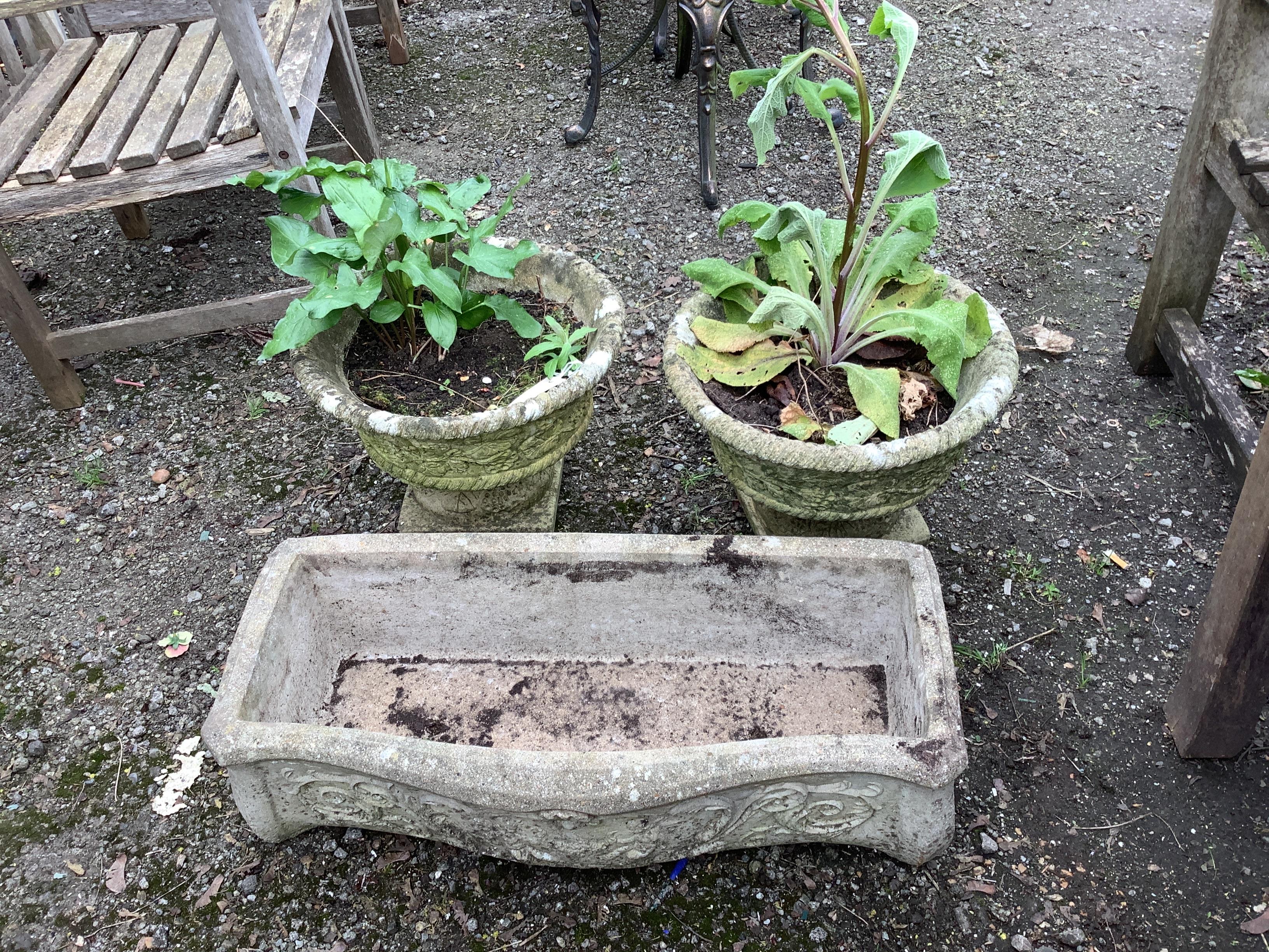 A pair of circular reconstituted stone garden planters, diameter 40cm, height 34cm, together with a rectangular serpentine front trough planter